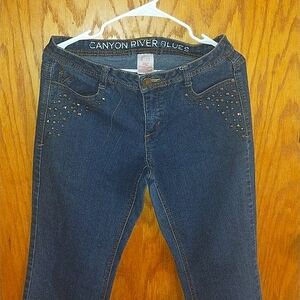 Women's navy blue jeans with detailed gold rhinestones